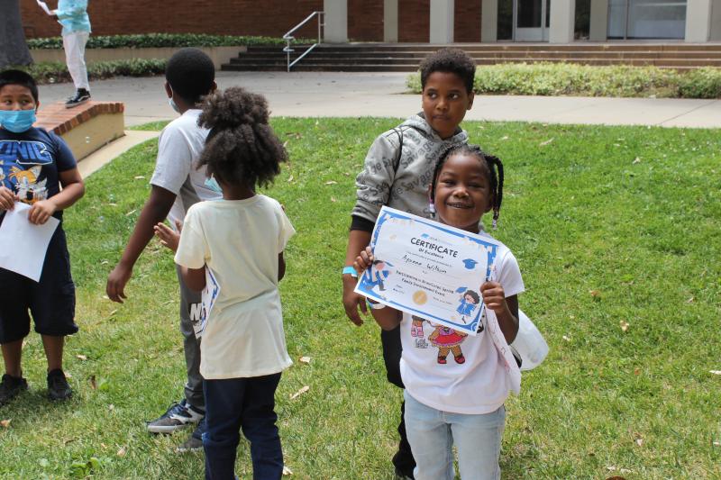 Student shows off certificate at Family Involvement Event at UCLA.